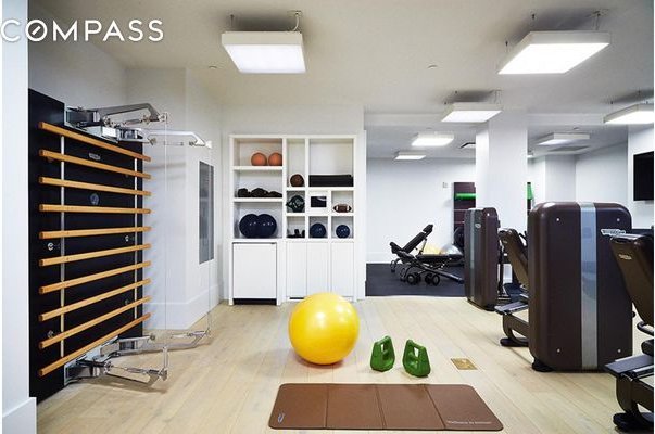 exercise room featuring wood finished floors