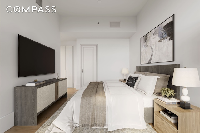bedroom featuring visible vents and wood finished floors