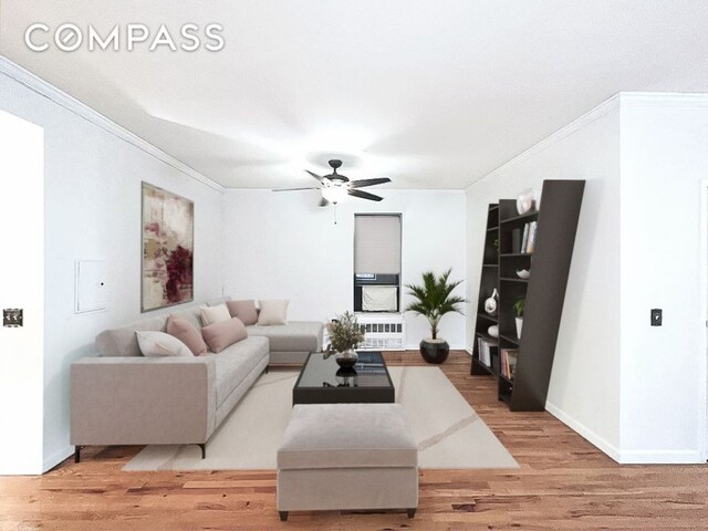 living room with ceiling fan, ornamental molding, and light hardwood / wood-style floors