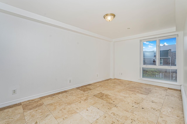 empty room featuring baseboards