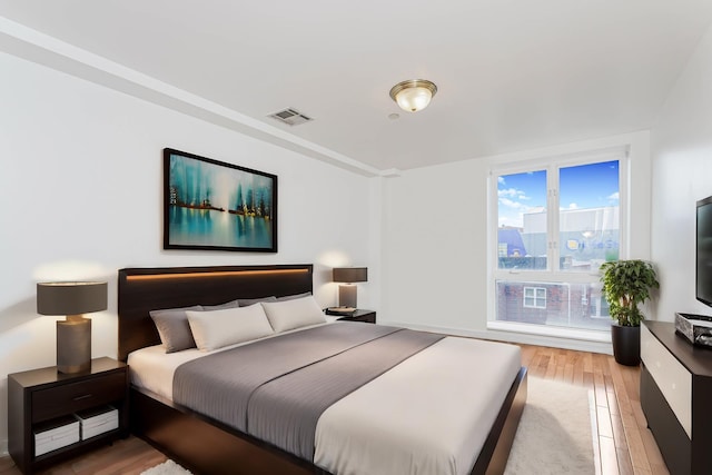 bedroom with visible vents and light wood finished floors