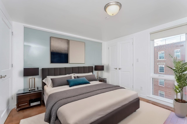 bedroom featuring baseboards and wood finished floors