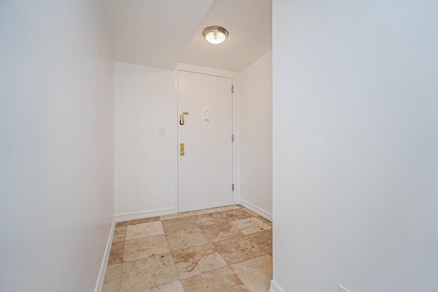 interior space featuring stone finish flooring and baseboards