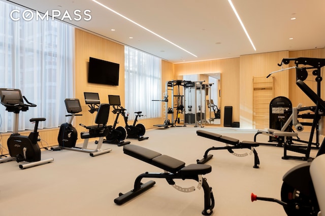 exercise room with wood walls