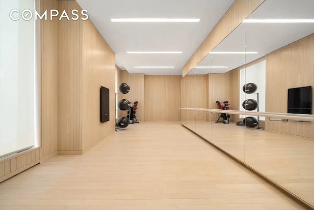 430 E 58th St Unit 16A, New York City, NY 10022 - exercise room featuring wood finished floors, wooden walls, and electric panel