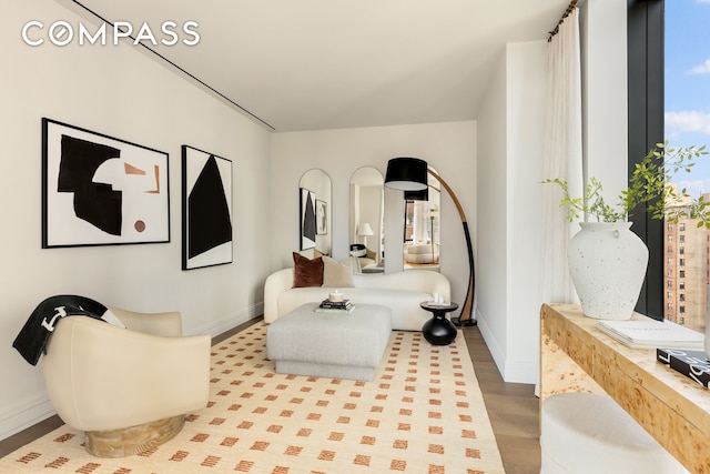 430 E 58th St Unit 16A, New York City, NY 10022 - living room featuring baseboards and wood finished floors