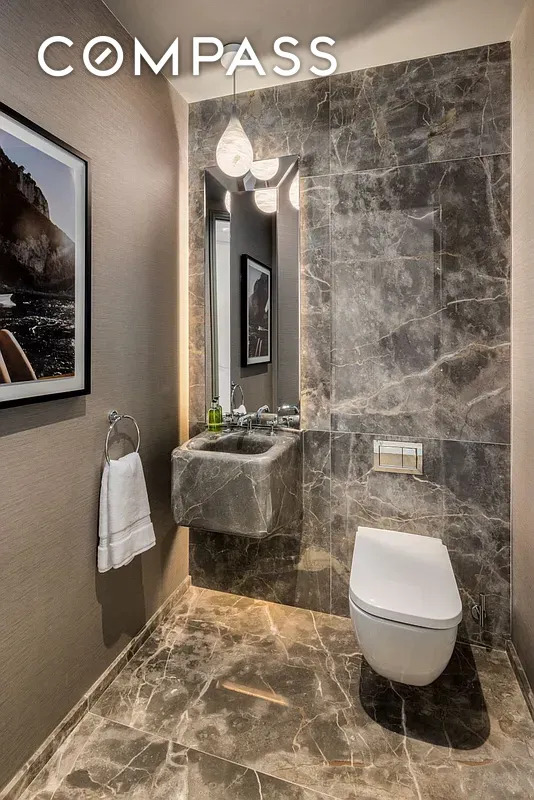 430 E 58th St Unit 16A, New York City, NY 10022 - half bathroom featuring marble tiled floors and toilet