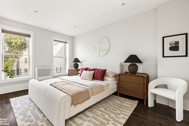 bedroom with recessed lighting, hardwood / wood-style flooring, and baseboards