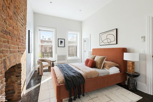 bedroom with baseboards and wood finished floors