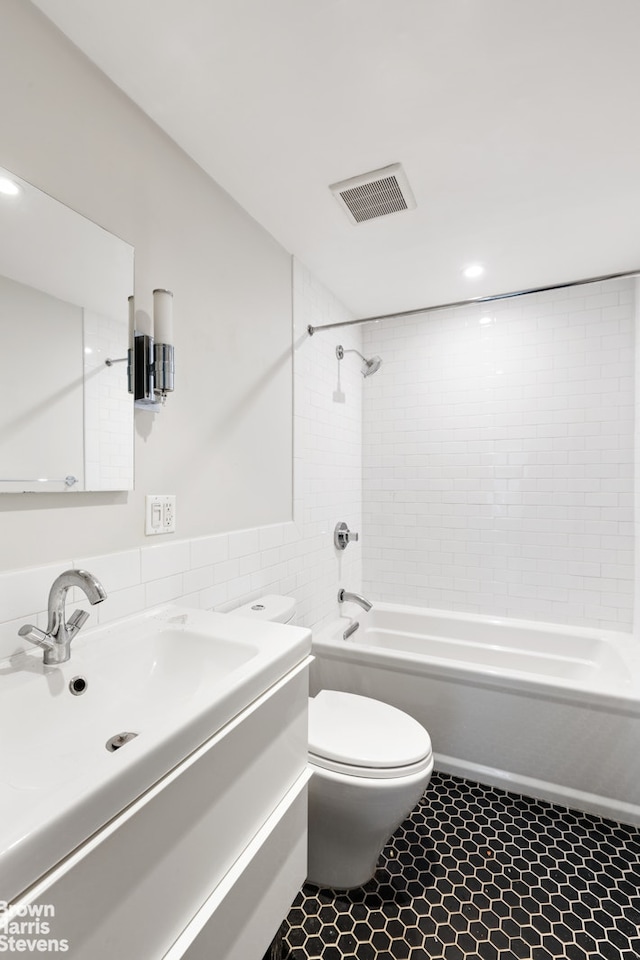 bathroom with visible vents, toilet, tub / shower combination, vanity, and tile patterned floors