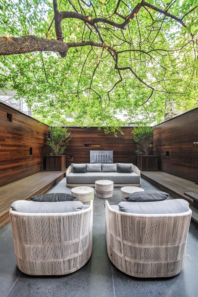 view of patio / terrace featuring outdoor lounge area and fence