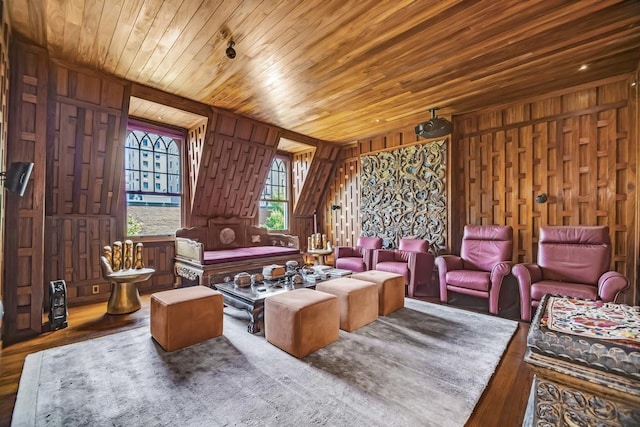 sitting room featuring wood finished floors, wooden walls, and wooden ceiling