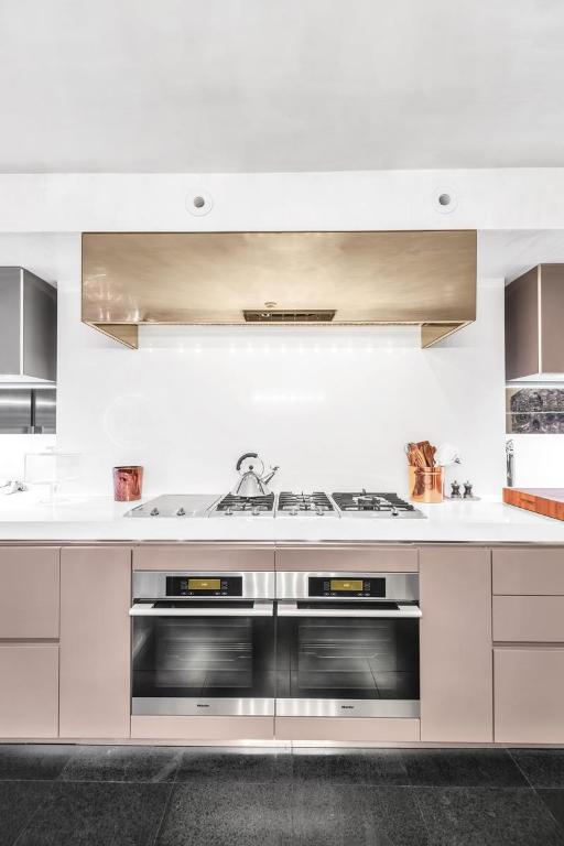 kitchen with stainless steel oven and exhaust hood