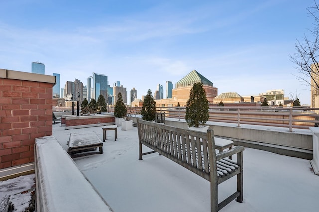 view of patio / terrace with a city view and fence