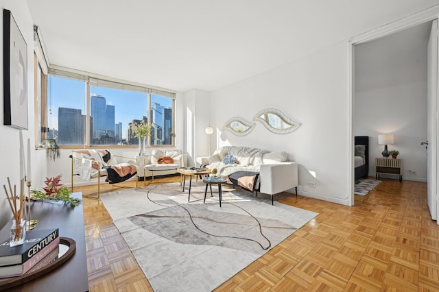 living area featuring a view of city and baseboards