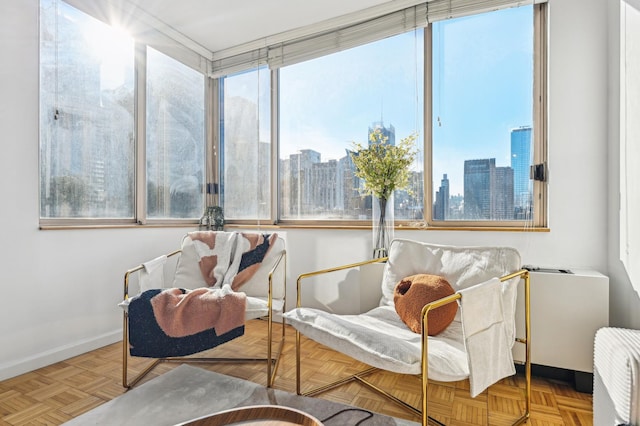 living area featuring a view of city and baseboards