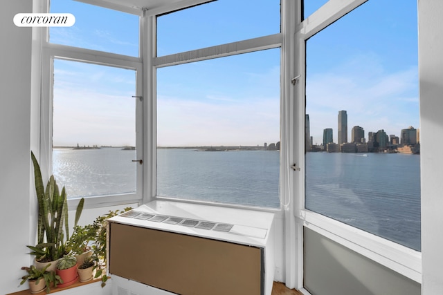 sunroom featuring a water view