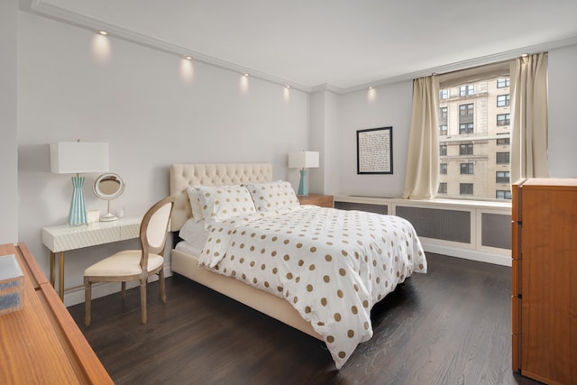 bedroom featuring ornamental molding and dark wood-type flooring