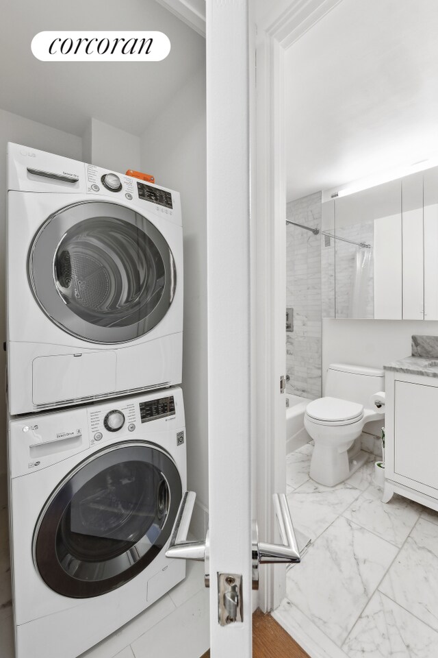 200 E 94th St Unit 1012, New York City, NY 10128 - washroom with estacked washer and dryer and marble finish flooring