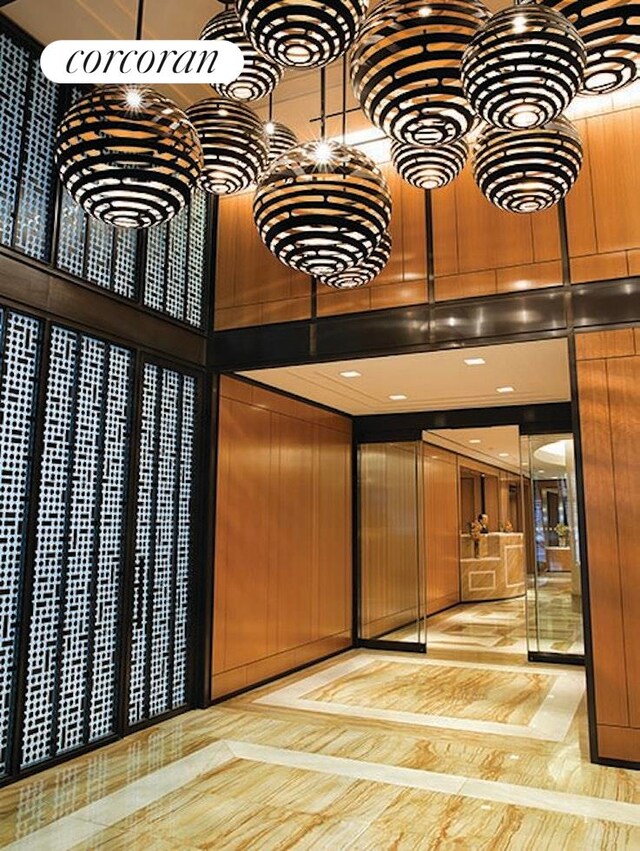 200 E 94th St Unit 1012, New York City, NY 10128 - community lobby with a towering ceiling and wood walls