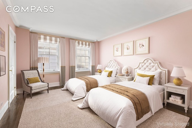 bedroom featuring crown molding, baseboards, and wood finished floors