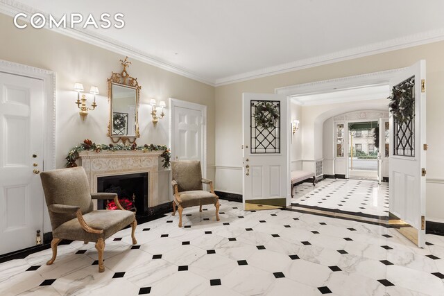 447 E 57th St Unit 14, New York City, NY 10022 - foyer featuring ornamental molding, arched walkways, a warm lit fireplace, and inlaid floor details