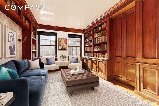 living room featuring a tray ceiling and ornamental molding