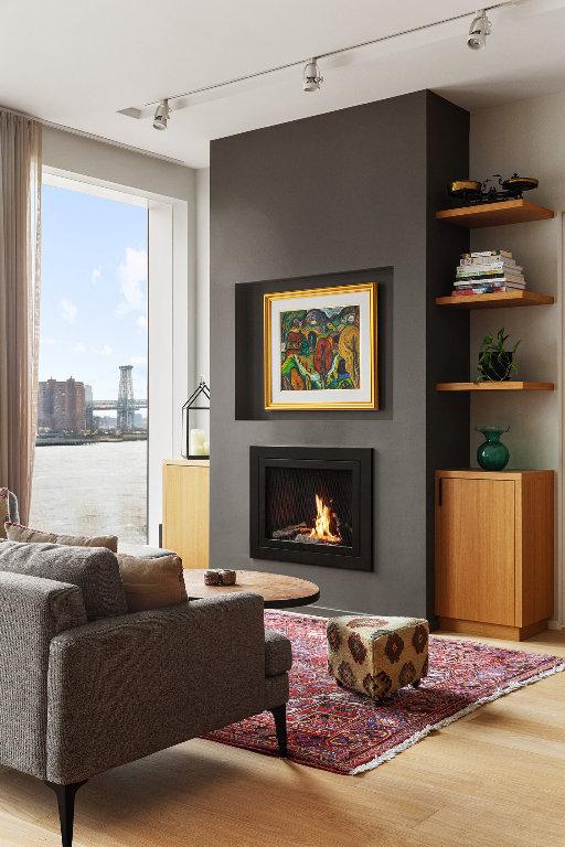 sitting room with rail lighting, a water view, hardwood / wood-style floors, and built in shelves