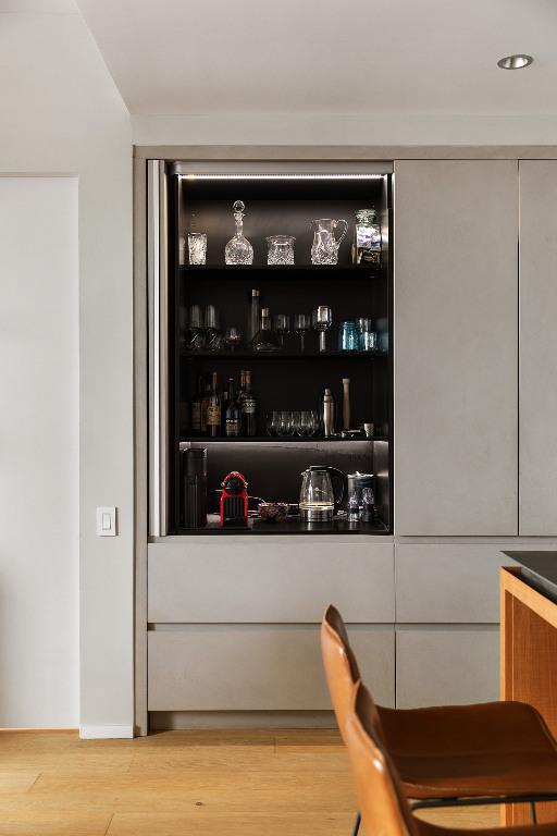 kitchen featuring decorative backsplash, light hardwood / wood-style flooring, a kitchen breakfast bar, and an island with sink