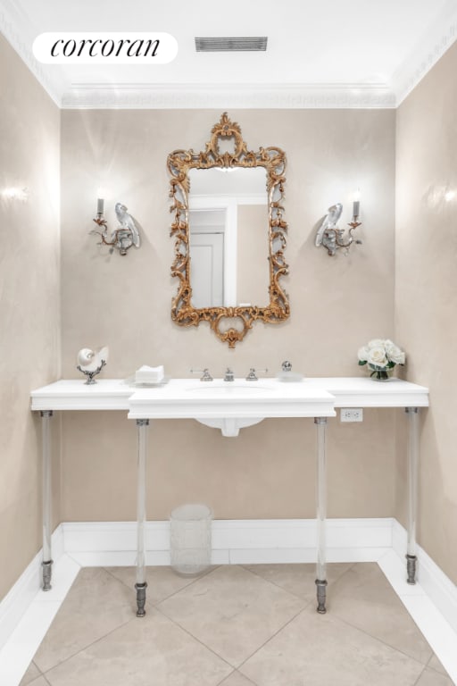 bathroom with baseboards, tile patterned flooring, visible vents, and crown molding