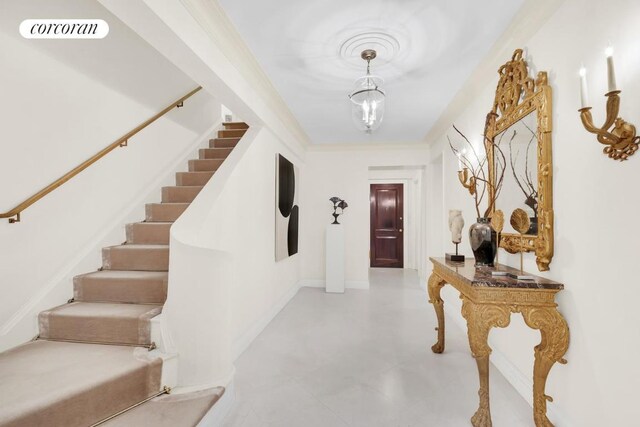 living room with beam ceiling and ornamental molding