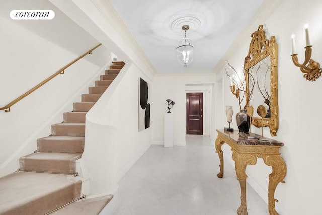 interior space featuring a notable chandelier, visible vents, baseboards, stairs, and ornamental molding