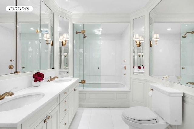 bathroom with toilet, shower / bath combination with glass door, a sink, and tile patterned floors