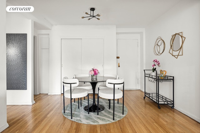 dining area with baseboards, visible vents, and light wood-style floors