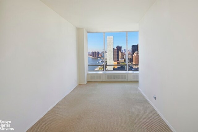 empty room featuring dark parquet flooring and a water view