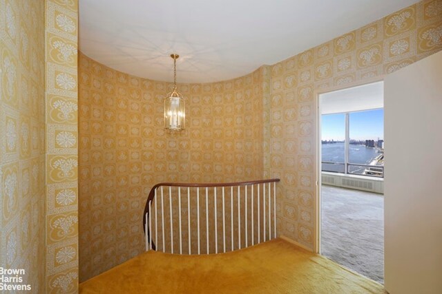 interior space featuring a notable chandelier, dark parquet floors, and a water view