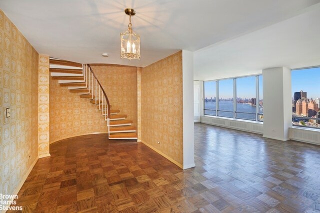 carpeted empty room with a water view