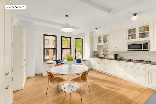 21 E 10th St Unit 2De, New York City, NY 10003 - dining space with light wood-type flooring, beamed ceiling, and baseboards