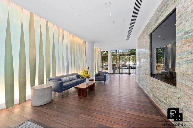 living room with a water view and hardwood / wood-style floors