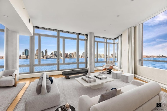 living room with hardwood / wood-style floors, expansive windows, and a water view