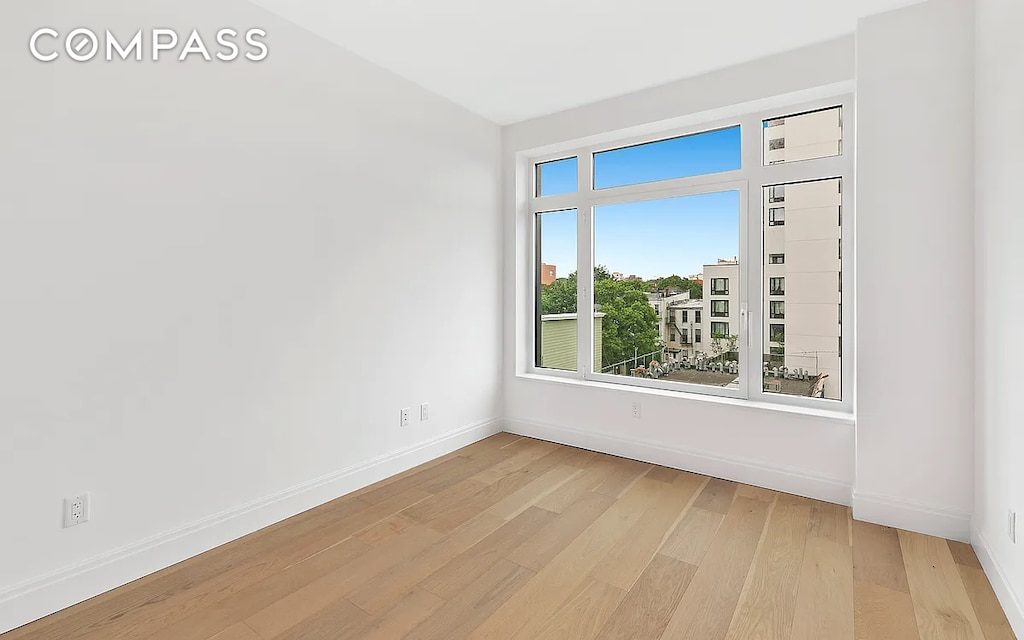 spare room with light hardwood / wood-style flooring