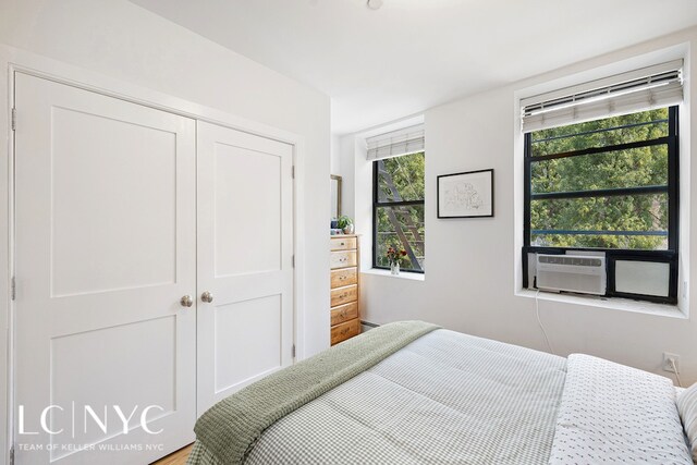 bedroom with cooling unit and a closet