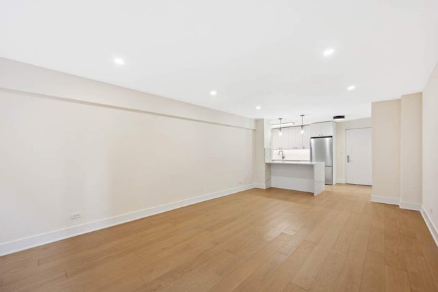 unfurnished living room featuring light hardwood / wood-style floors