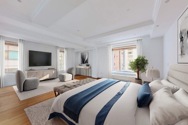 bedroom featuring crown molding, a tray ceiling, and light wood-type flooring