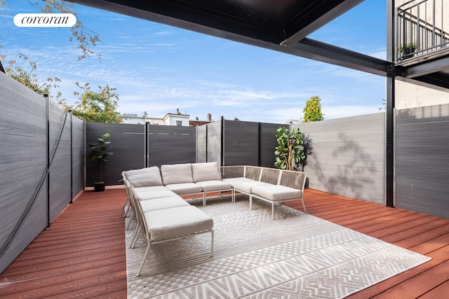 deck featuring a fenced backyard and outdoor lounge area