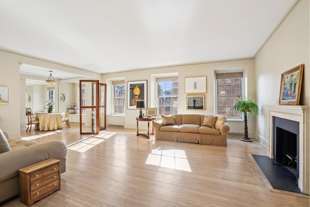 living room featuring ornamental molding and light wood-type flooring