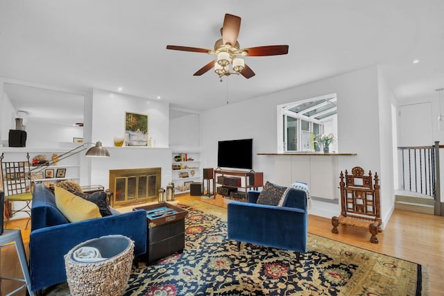 living room featuring ceiling fan and hardwood / wood-style floors