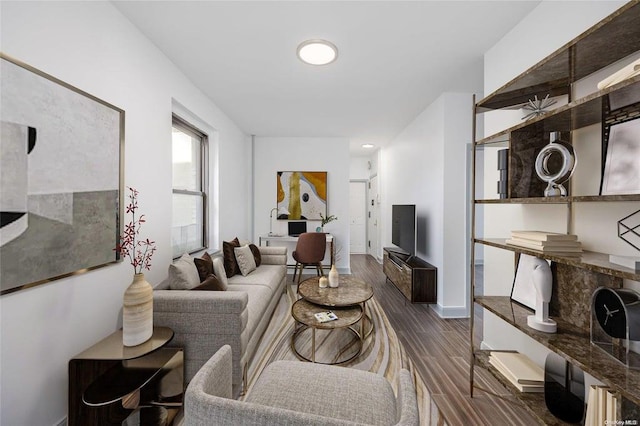 living room with baseboards and wood finished floors