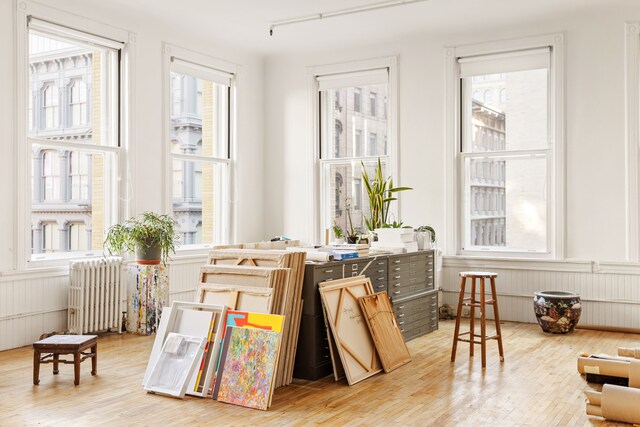 bedroom with radiator, light hardwood / wood-style flooring, and a closet