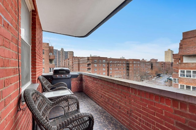 balcony with a view of city and grilling area